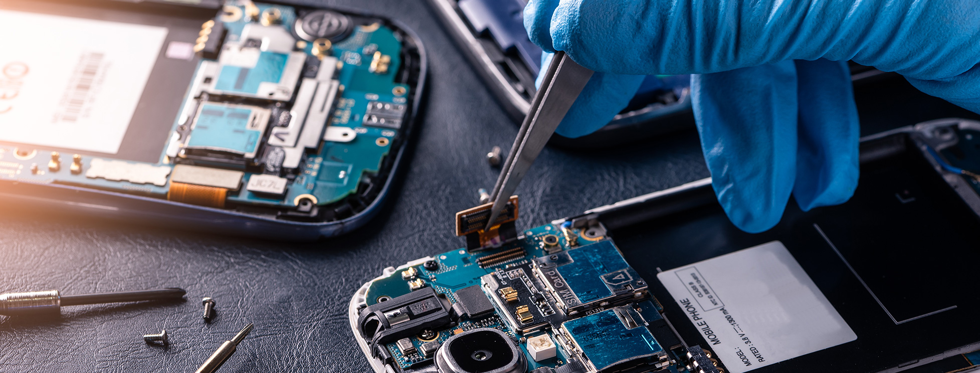 Phone repair tools and a device being serviced